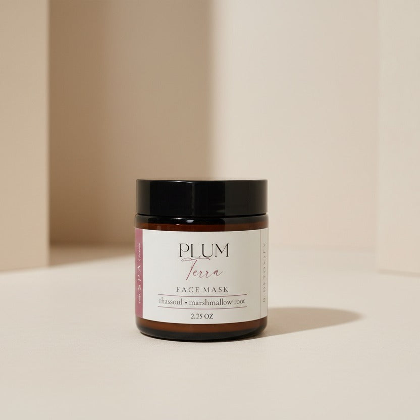 Jar of Plum Terra face mask on a beige background