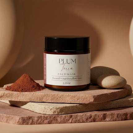Jar of Plum Terra face mask on a stone surface with natural ingredients
