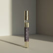 Cologne bottle labeled 'Volume III' on a neutral background