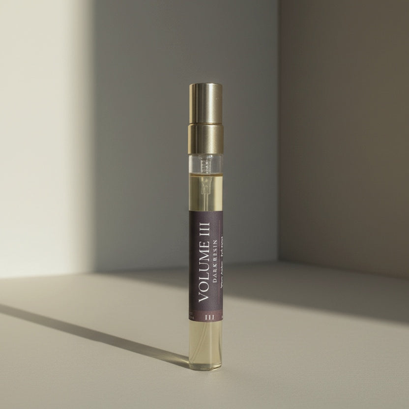 Cologne bottle labeled 'Volume III' on a neutral background